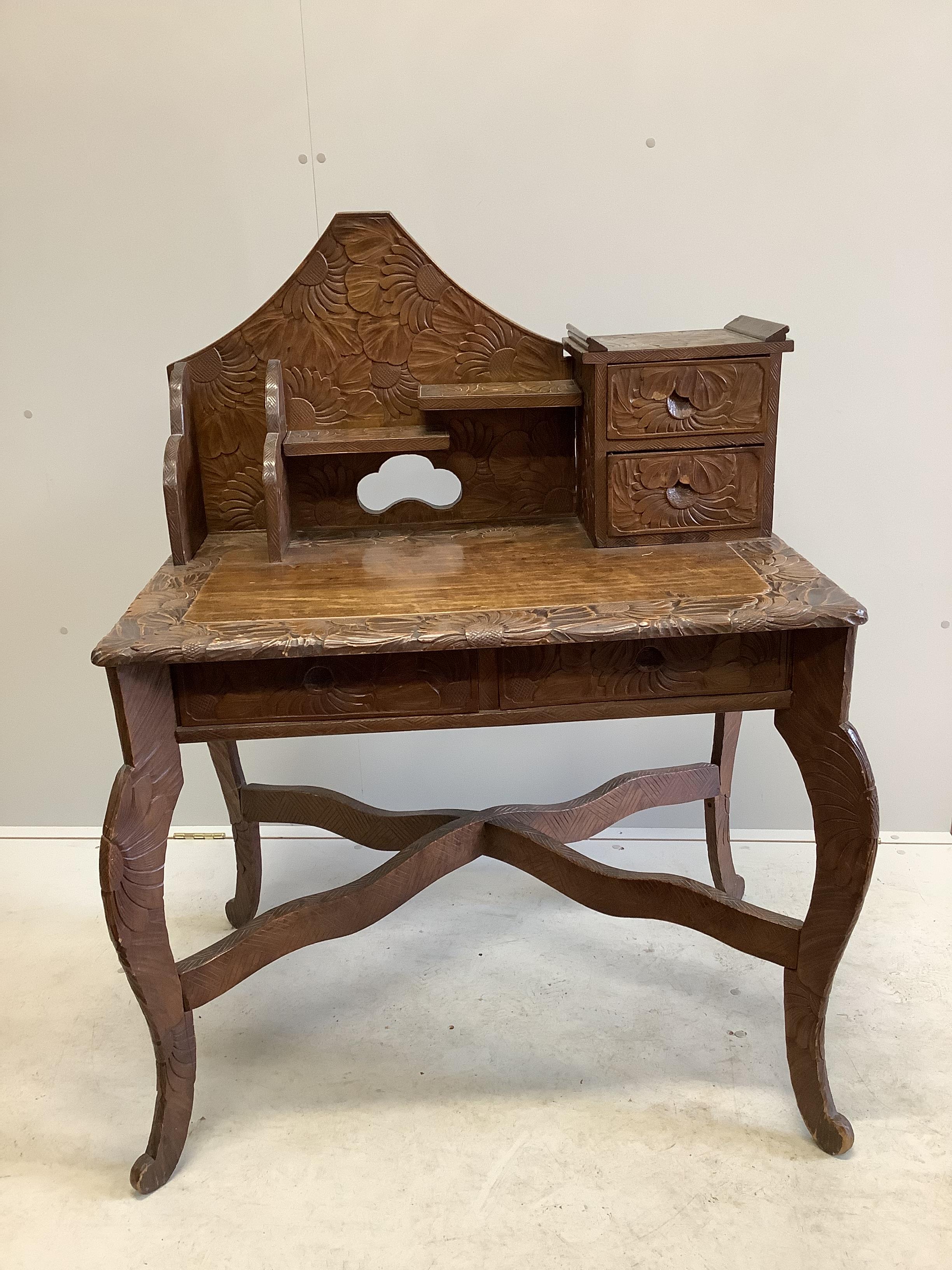 An early 20th century Liberty retailed Japanese carved wood desk, width 94cm, depth 63cm, height 122cm